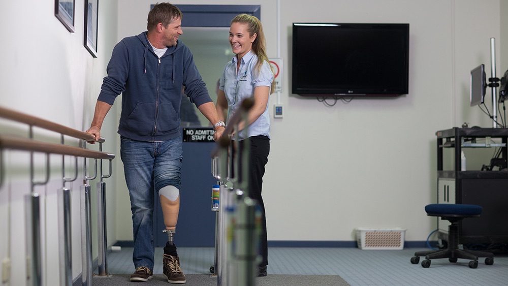 REHAB-Orthotics-wide Man with prosthetic leg in rehabilitation session.